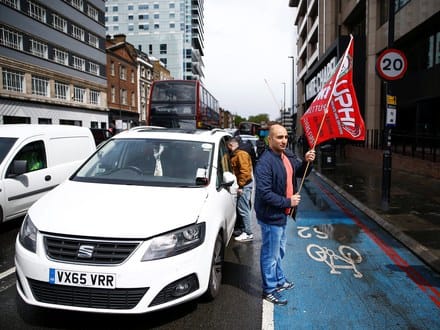 Ride-hail drivers protesting outside the Uber office in London on Wednesday.